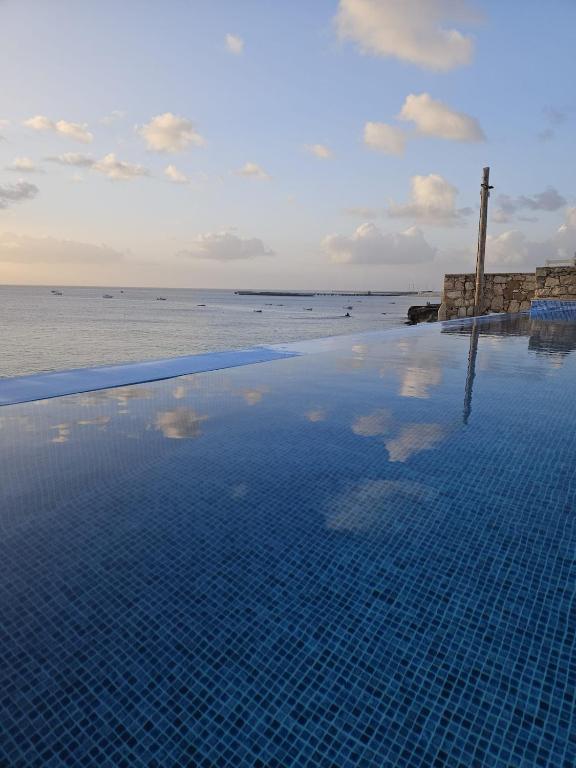 a swimming pool with a view of the ocean at Maio Sweet Tartaruga in Vila do Porto