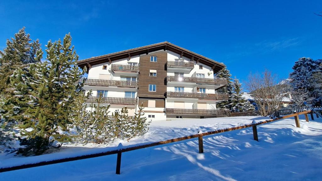 a building with snow in front of it at Damiez (205 Li) in Lenzerheide
