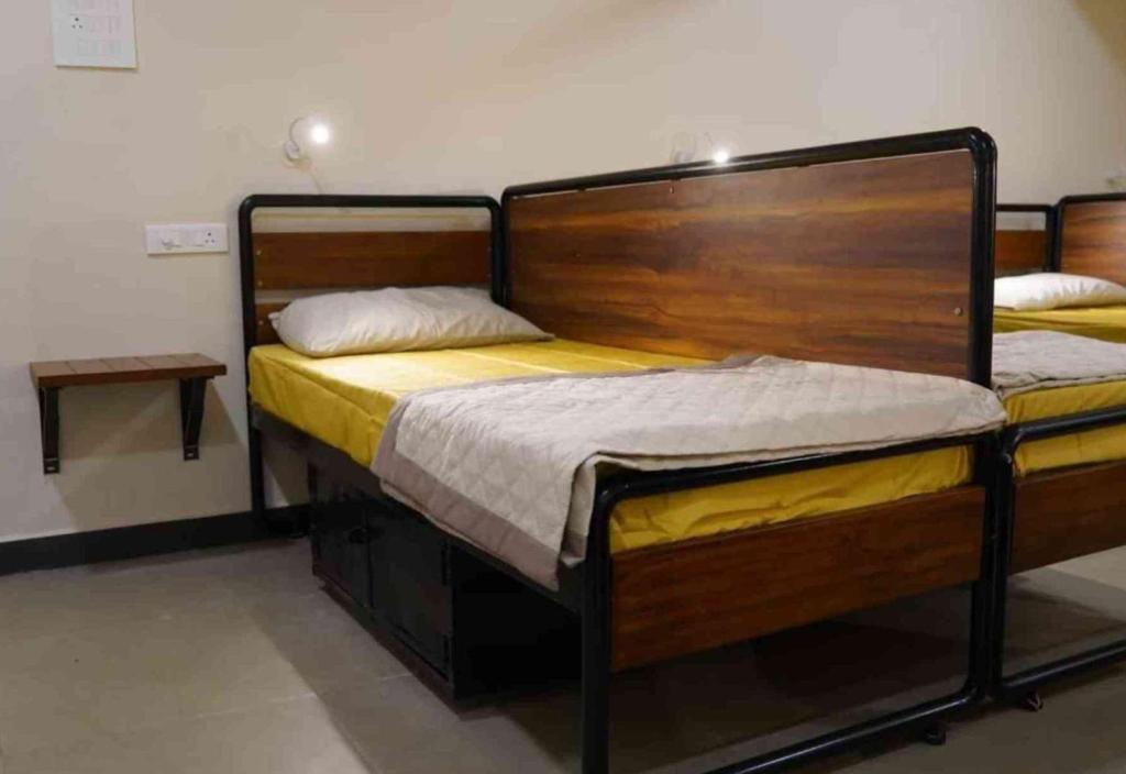 two twin beds in a room with at Sukhnidras Dormitory in Hyderabad