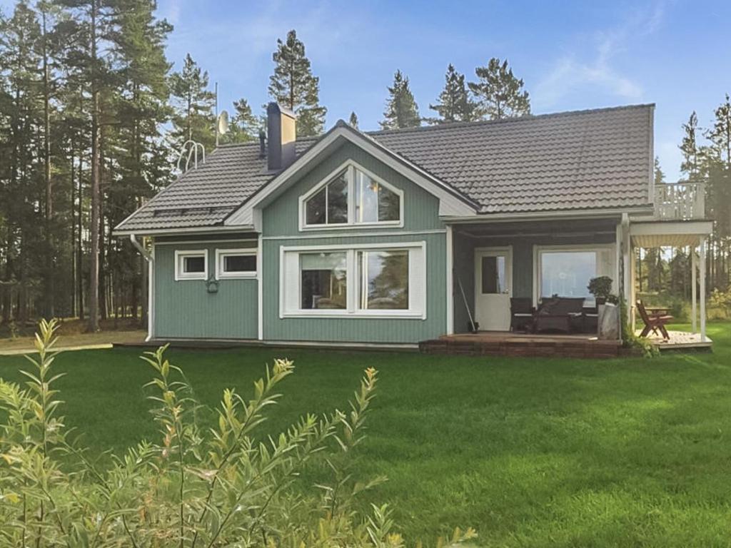 a small green house with a large yard at Holiday Home Merivanamo by Interhome in Haukipudas