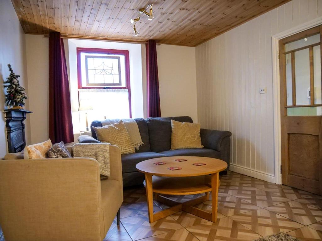 a living room with a couch and a table at Orchard House - Dingle Town Centre in Dingle