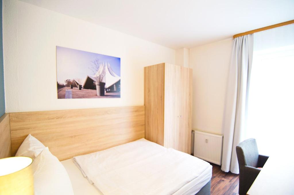 Postel nebo postele na pokoji v ubytování BlnCty Hotel