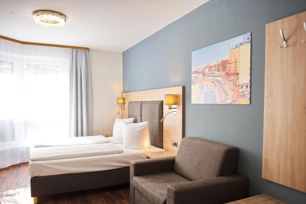 Postel nebo postele na pokoji v ubytování BlnCty Hotel