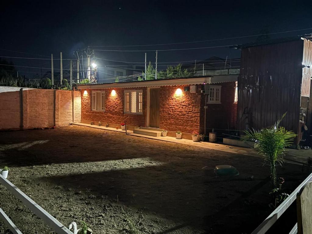 a small house at night with lights on it at Engineers Retreat in Srinagar