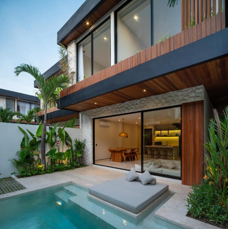 an exterior view of a house with a swimming pool at La Finca Bingin in Uluwatu