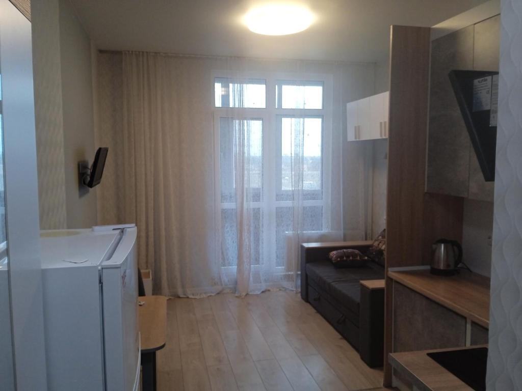 a small living room with a couch and a window at Квартира-студія in Odesa