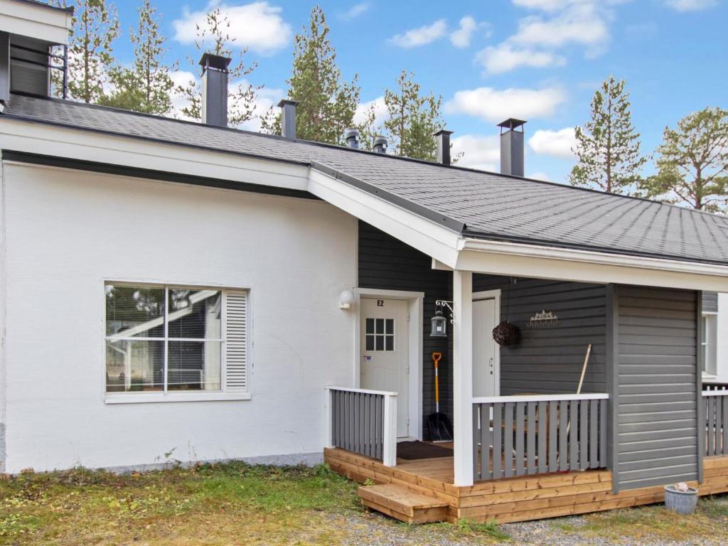 a house with a porch and a deck at Holiday Home Kätkäläinen e 2 by Interhome in Levi