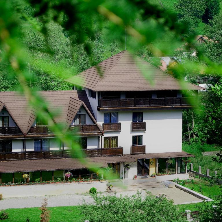 a large building with brown roof at Hanul Simonului in Bran