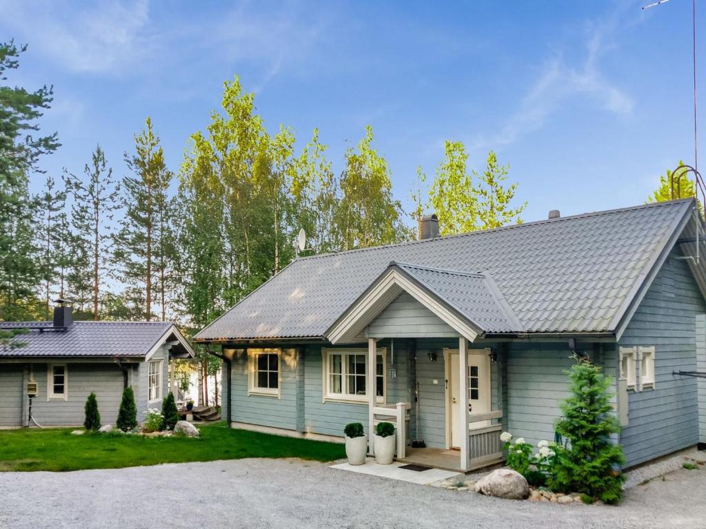 a blue house with a gray roof at Holiday Home Sointukallio by Interhome in Savonlinna