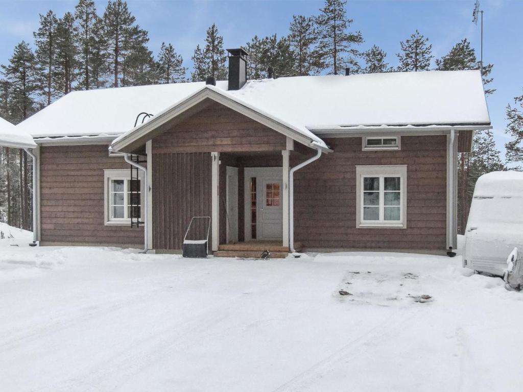 a small house with snow on the ground at Holiday Home Seppola by Interhome in Ruka