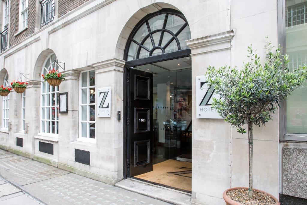 a store front with a black door on a street at The Z Hotel Victoria in London