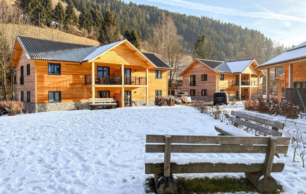 a group of wooden houses in the snow at Ferienwohnung 1 Stock in Afritz