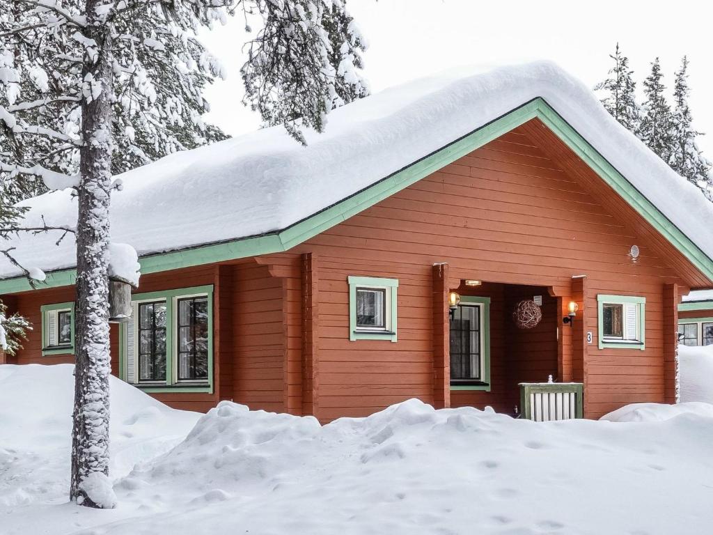 a small red house with snow on the roof at Holiday Home Lomamaja 3 by Interhome in Raattama
