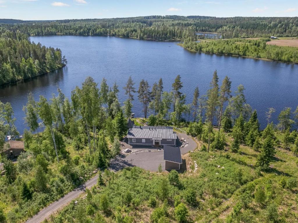 an aerial view of a house on the shore of a lake at Holiday Home Paula by Interhome in Lihavanpää