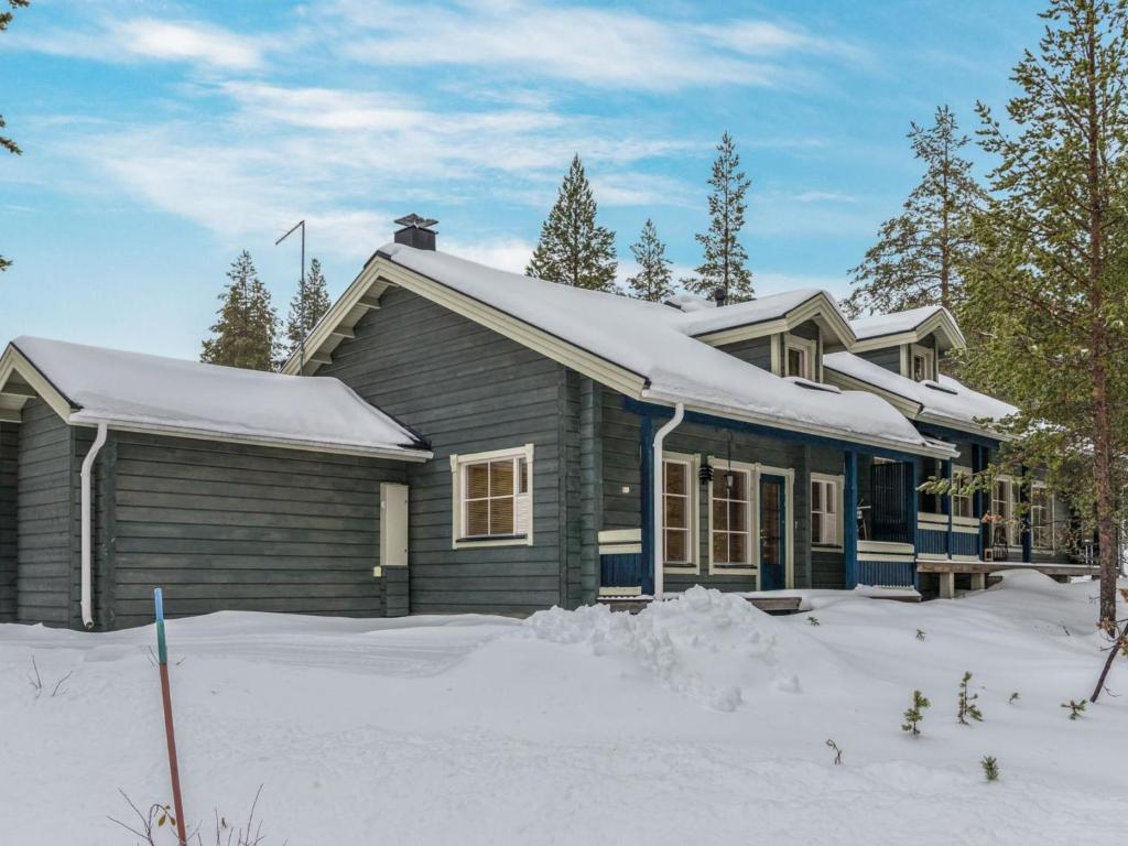 a house with snow on top of it at Holiday Home Ylläskaira a by Interhome in Äkäslompolo