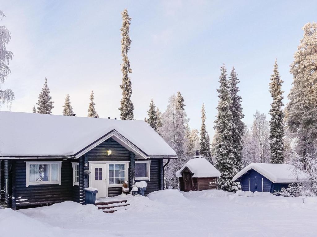 a cabin in the snow with snow covered trees at Holiday Home Isopyhänmaa by Interhome in Salla