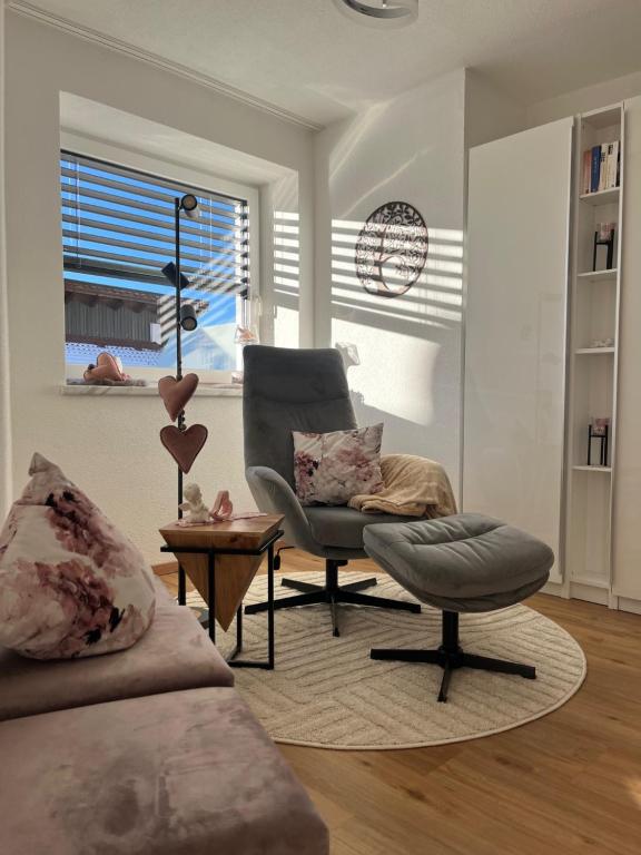 a living room with a chair and a window at Activ-Family-Apart-Wisiol-Pitztal Sommercard inklusive in Jerzens