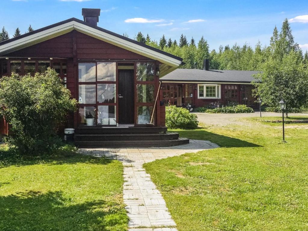 a house with a pathway leading to the front of it at Holiday Home Eden by Interhome in Kuusa