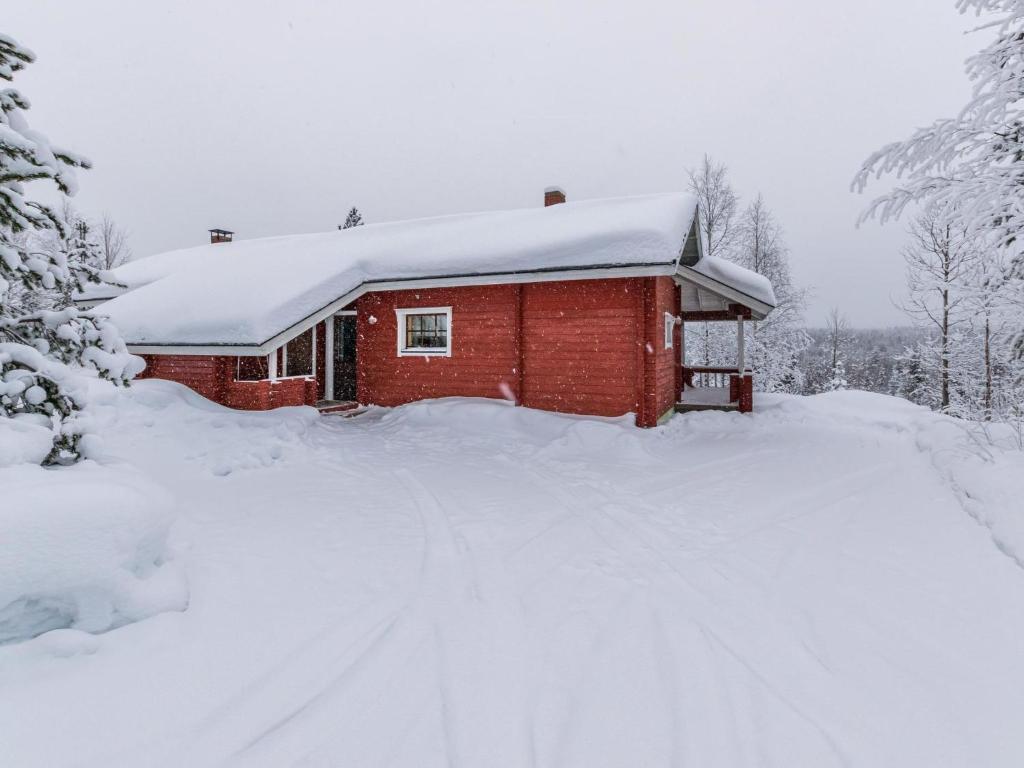 a red brick house with snow on the roof at Holiday Home Lomapesä 2b by Interhome in Kotila