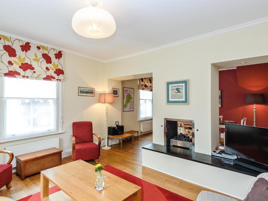 a living room with a tv and a fireplace at Lapwing in Yarmouth