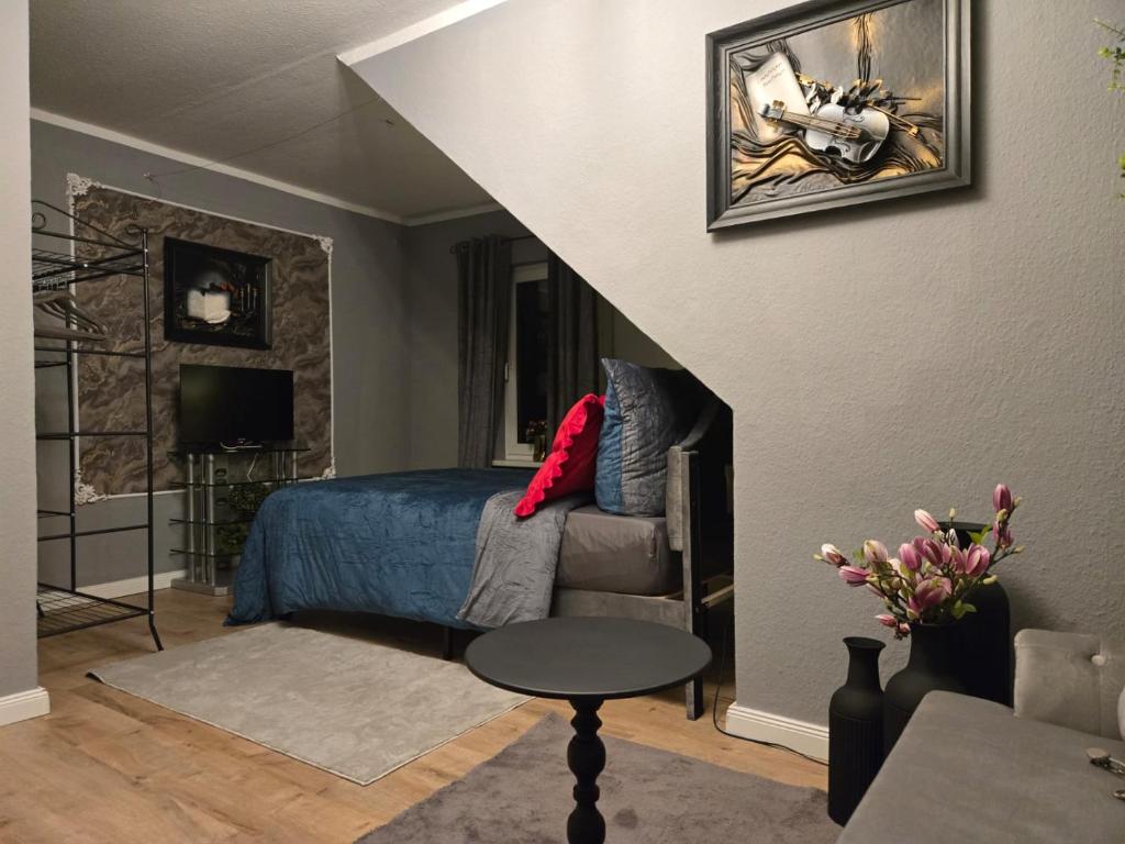 a bedroom with a bed and a chair and a table at Gästezimmer vom Restaurant Saustall in Mestlin