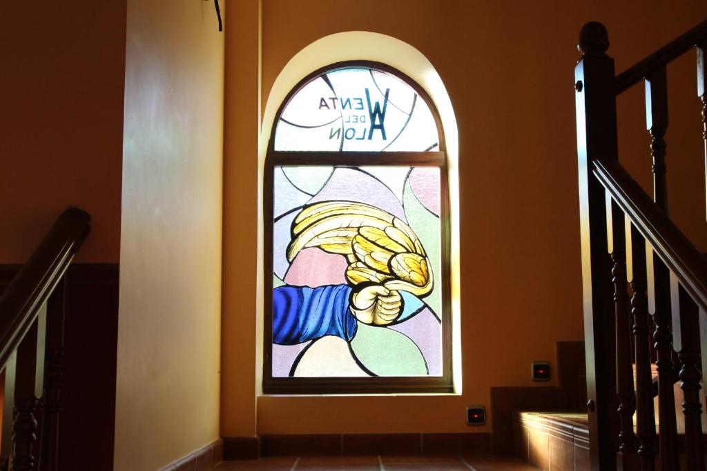 a stained glass window on the side of a staircase at Hotel Rural Venta Del Alon in Villalón de Campos