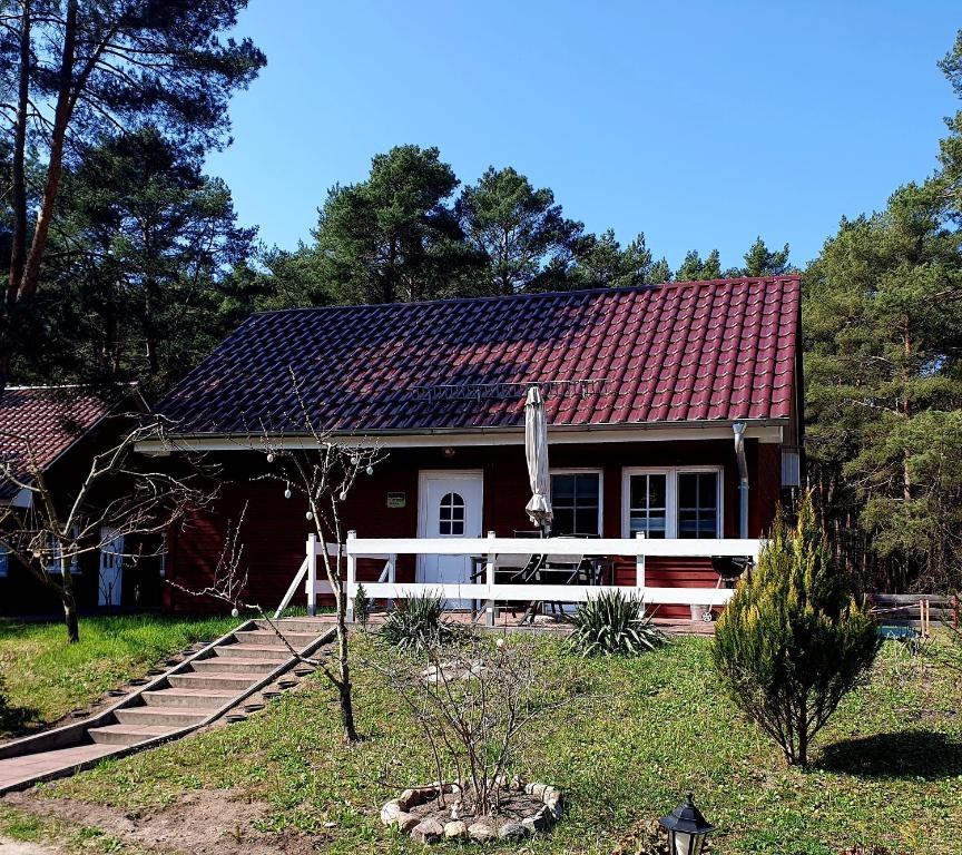 a house with a red roof and a porch at Ferienhaus Weitblick in Zossen