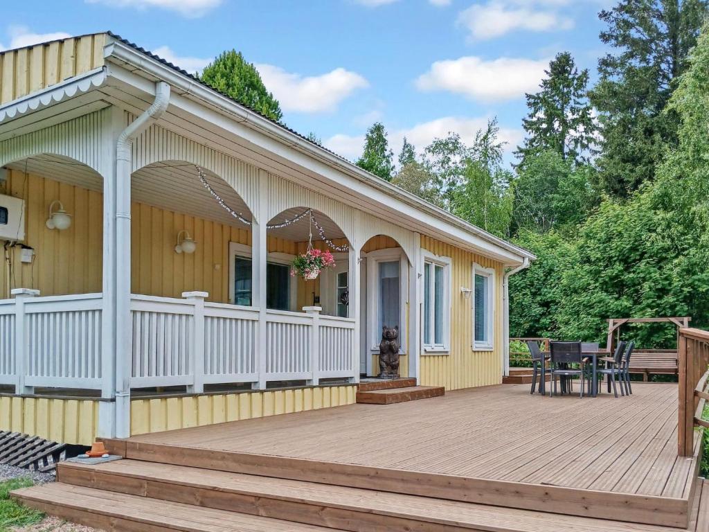 a house with a large wooden deck with a porch at Holiday Home Salmiranta by Interhome in Jämijärvi