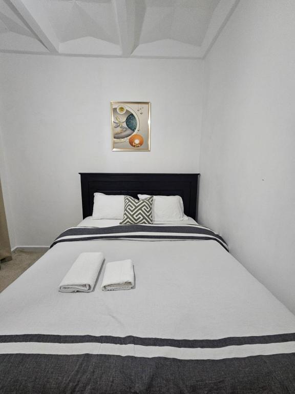 a bedroom with a large white bed with two towels at Upscale homes in Ongata Rongai 