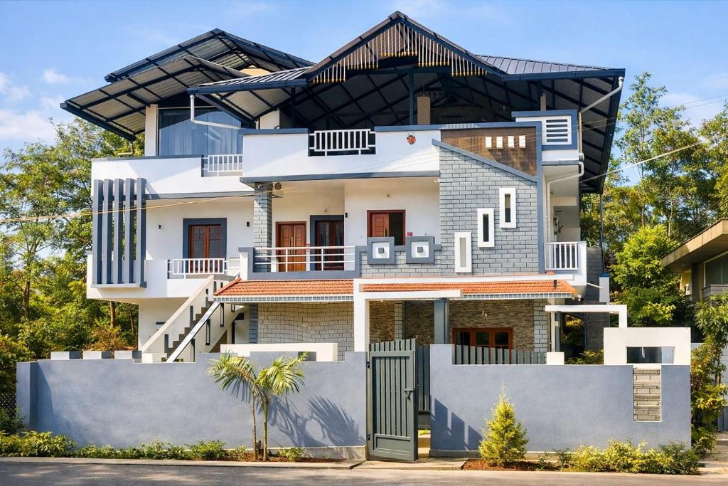 a house with a gate in front of it at Aroha luxury homestay in Madikeri