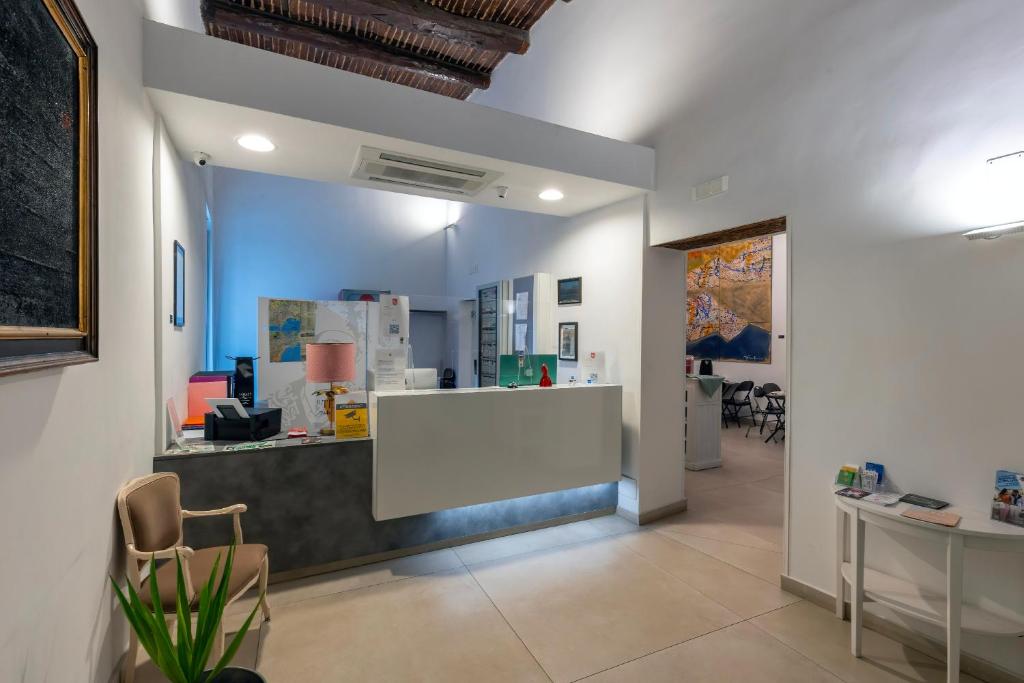 a lobby with a white counter in a room at Il Tesoro Smart Suite & SPA in Naples