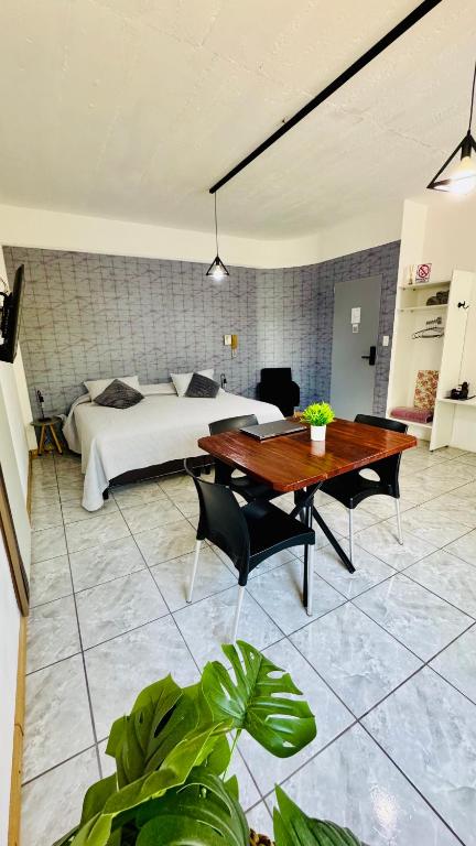 a bedroom with a bed and a table and a bed at Monoambiente Eldorado 2 in Eldorado