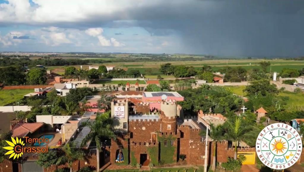 an aerial view of a town with a ferris wheel at Pousada Complexo Girassol in Dourados