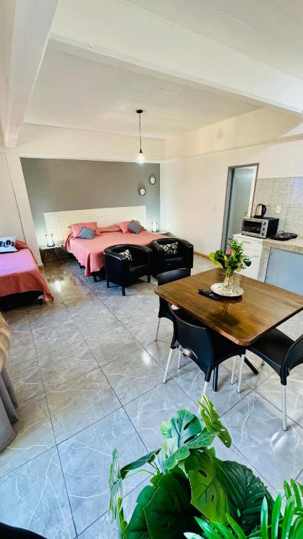 a living room with a bed and a table at Monoambiente Eldorado 6 in Eldorado