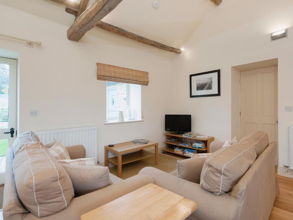 a living room with two couches and a tv at Hurworth - 25565 in Knapton