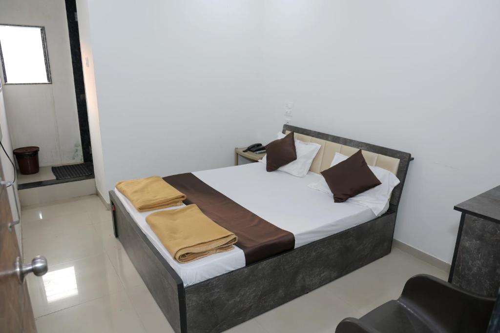 a bedroom with a bed in a room at Hotel Sky Blue in Surat