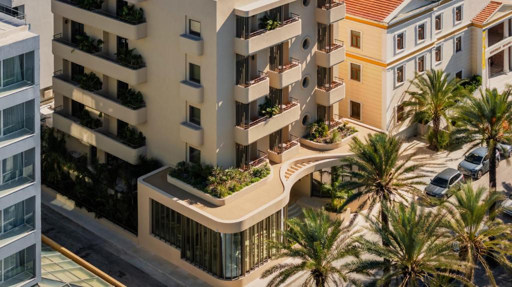 an overhead view of an apartment building with palm trees at Cento Palme in Rhodes Town