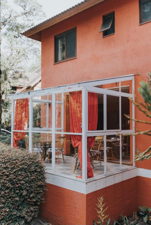 a screened in porch on the side of a house at Pousada Pinhão e Poesia in Canela
