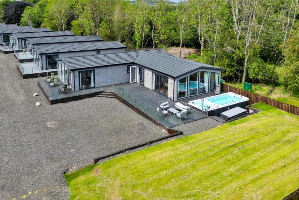 an aerial view of a house with a swimming pool at Finest Retreats - Silverwood Executive Chalet in Errol