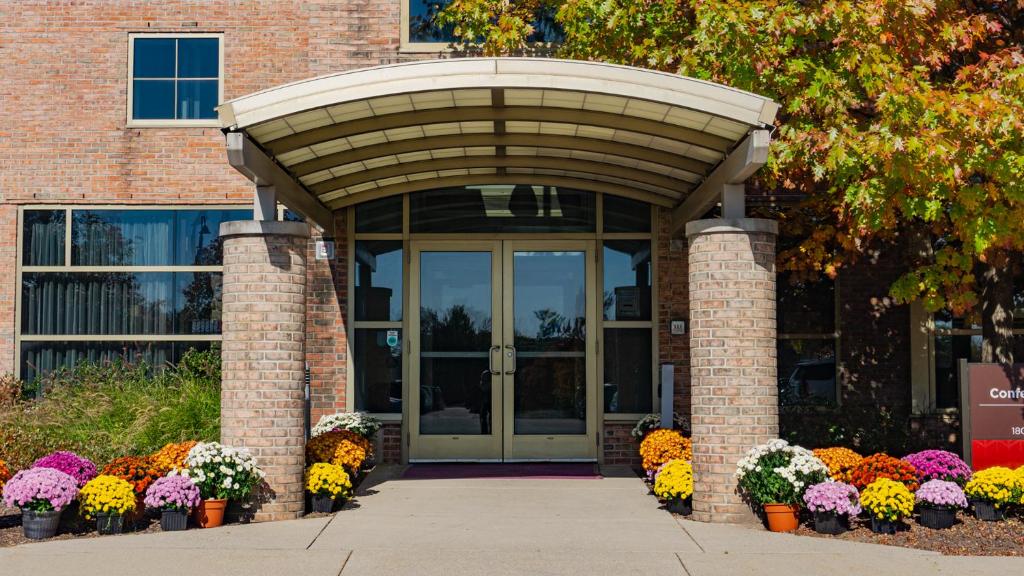 a entrance to a building with flowers in front of it at Prince Conference Center & Hotel in Grand Rapids