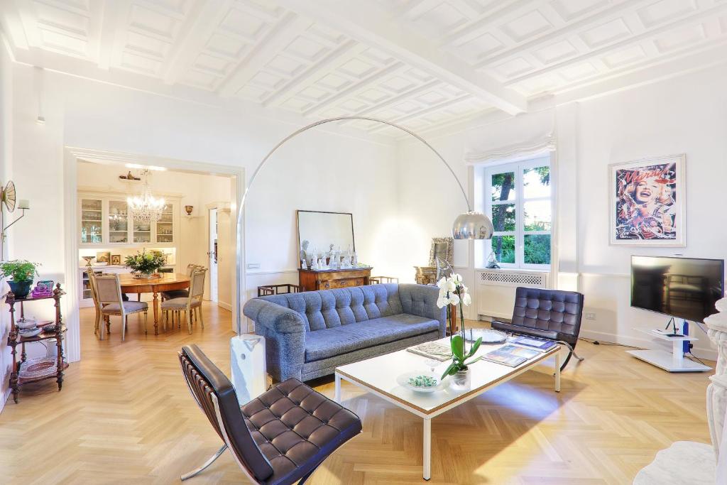 a living room with a blue couch and a table at Villa Lalen Sorrento Private Luxury Residence with Garden, Terrace & Jacuzzi in Sorrento