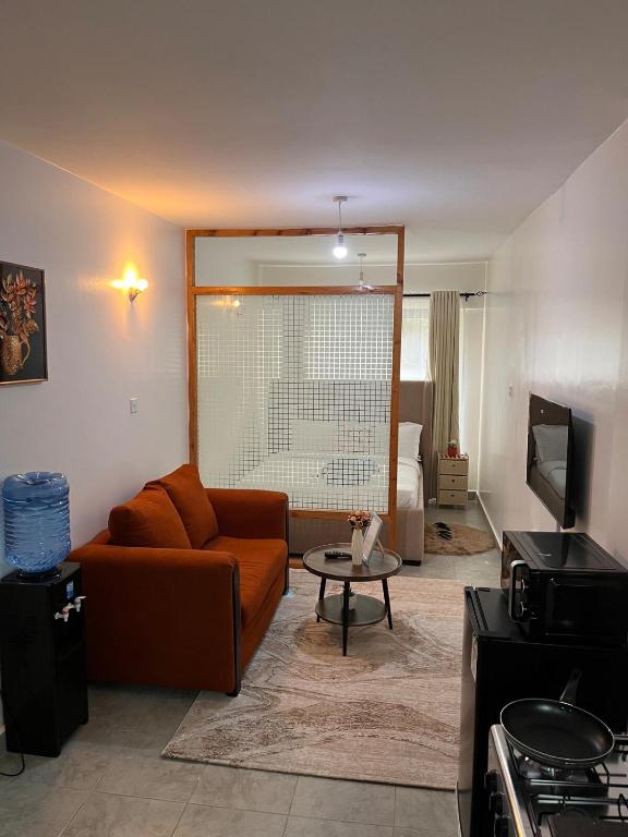 a living room with a couch and a table at Ems Haven Apartment in Ongata Rongai 