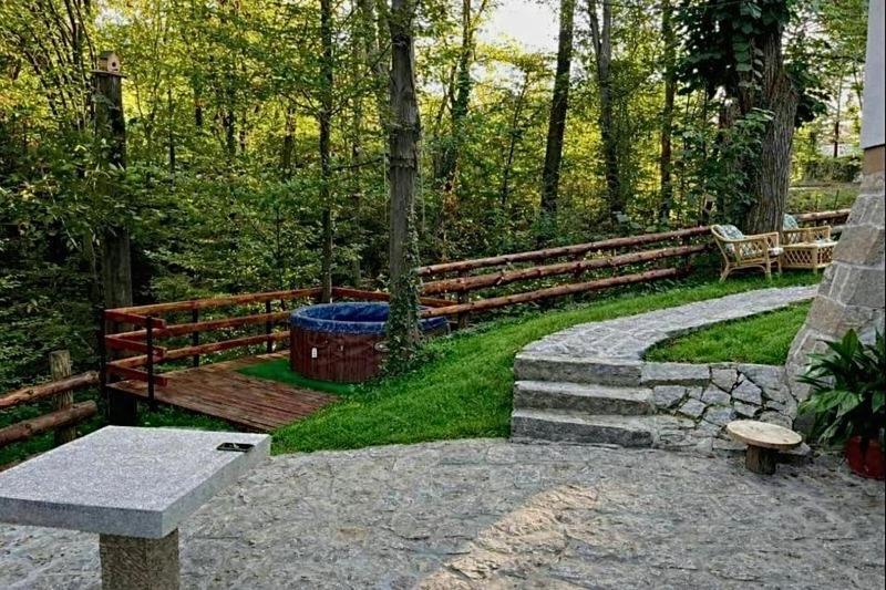 a park with a wooden fence and a bench at Šumarak Weekend House in Arandelovac