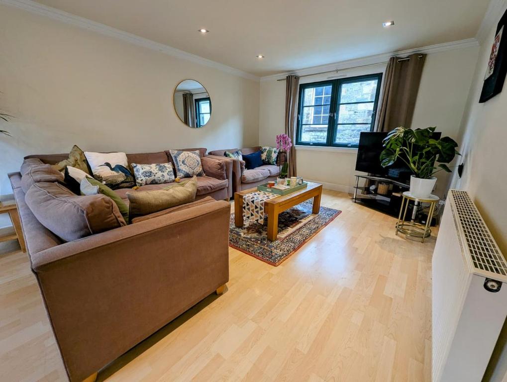 a living room with a couch and a table at City Center Gem-4Bd House! in Edinburgh
