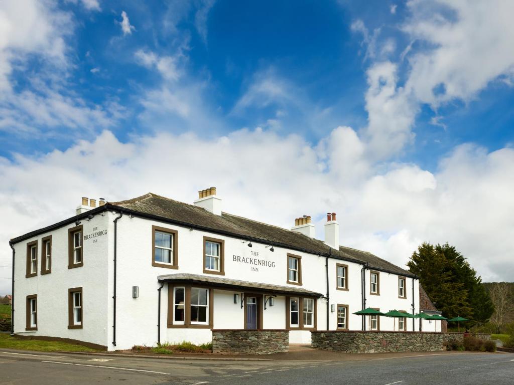a white building on the side of a road at The Brackenrigg Inn in Watermillock