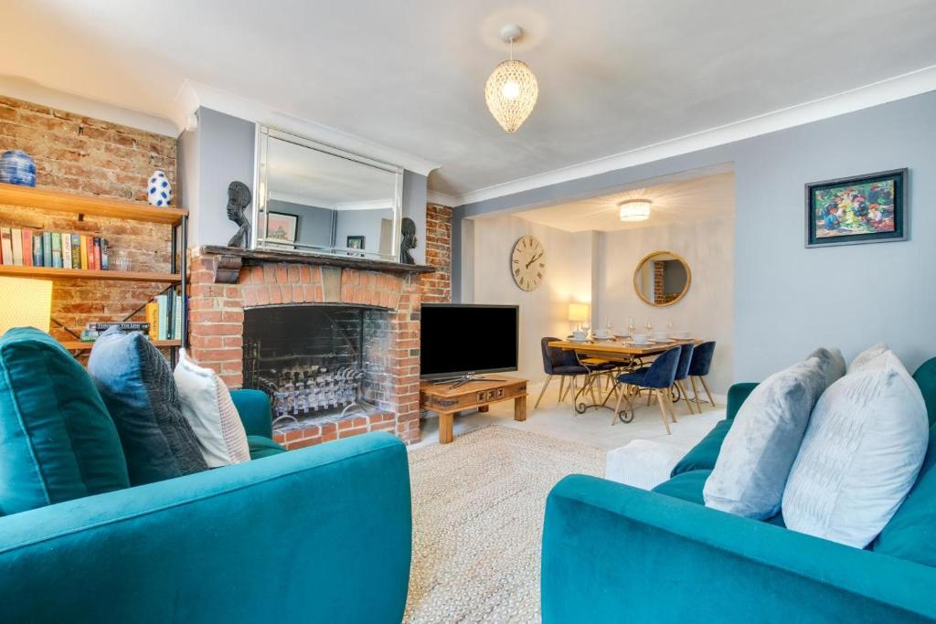 a living room with blue furniture and a fireplace at 4 Bed in Rottingdean oc-bbrott in Rottingdean