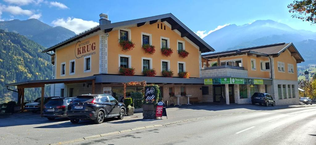 a large building with cars parked in front of it at Ferienwohnung Krug in Wenns
