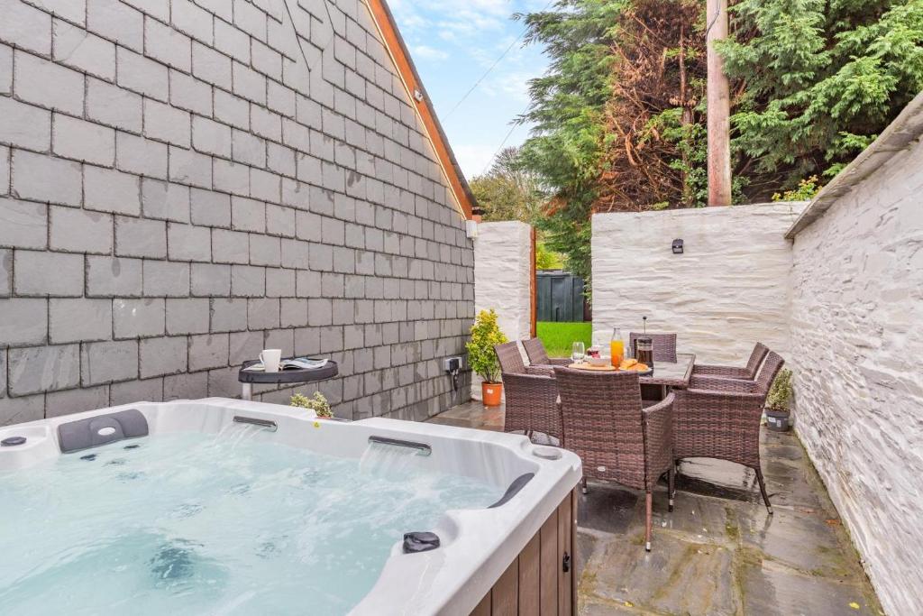 a hot tub in a backyard with a table and chairs at 3 Bed in Yeolmbridge oc-t30293 in Werrington