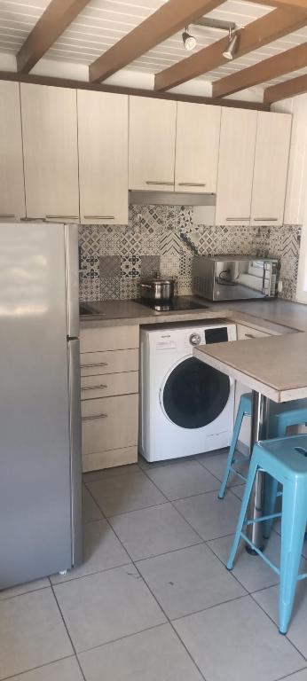 a kitchen with a white refrigerator and a dishwasher at Hotel y Cabañas La Magia del Sur in Valdivia