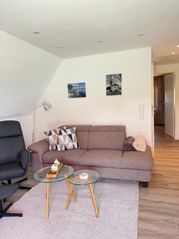 a living room with a couch and a table at Ferienwohnung Haus Grenzwald in Nettetal